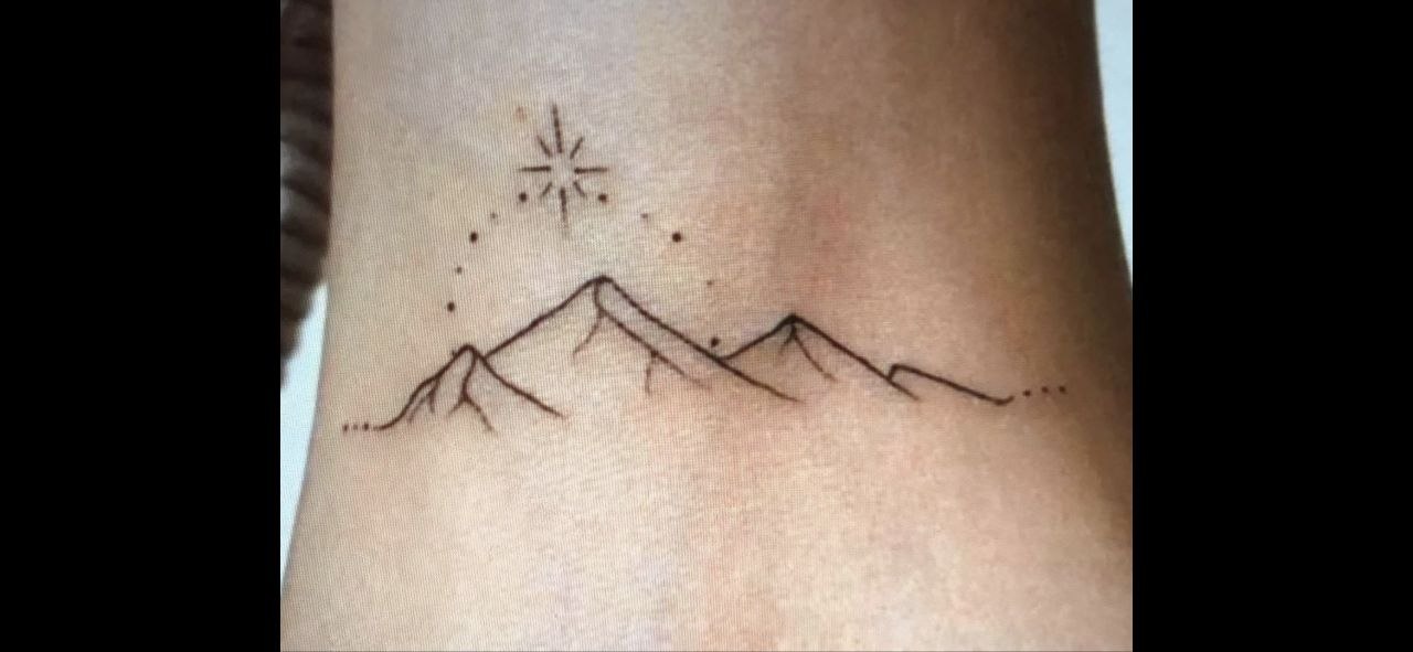 Fineline tattoo: bergen met ster en stippellijn